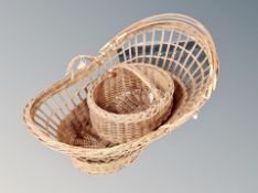 A vintage wicker Moses basket and a further shopping basket