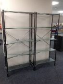 A pair of contemporary metal and glass five tier open shelves,