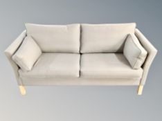 A Scandinavian three seater settee in grey upholstery
