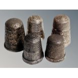 Five silver thimbles