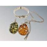 Two Baltic amber pendants, one on silver chain,
