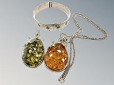 Two Baltic amber pendants, one on silver chain,