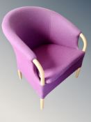 A beech framed tub armchair in purple upholstery