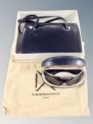 A lady's Eros black leather shoulder bag together with a pair of Prada sunglasses in box