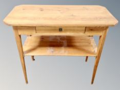 A pine two tier occasional table,