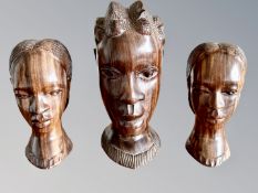 An African carved wooden bust, and a further similar pair,