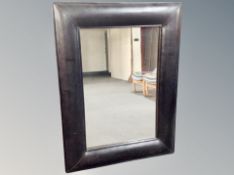 A black leather framed cushion mirror 91 cm x 122 cm