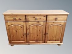 A contemporary stained pine sideboard,