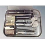 A tray containing diving knives, Ever-Ready razor in Bakelite box, gun cleaning rod etc.