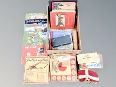 A box containing Bridge set, Danish cigarette card albums, playing cards.