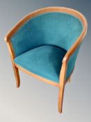 A tub armchair in turquoise upholstery