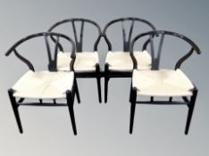 A set of four Scandinavian elbow chairs with rattan seats