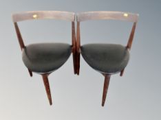 A pair of 20th century Danish teak tripod chairs with black vinyl seats
