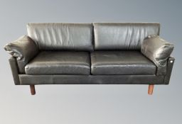A pair of Scandinavian black leather three seater settees
