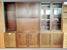 A Scandinavian mahogany effect three part section bookcase with glazed doors,