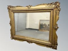 An early 20th century gilt and gesso overmantle miror 133 cm x 100 cm