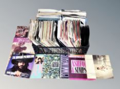 A basket of mid 20th century and later vinyl 7" singles to include Lindisfarne, Diana Ross,