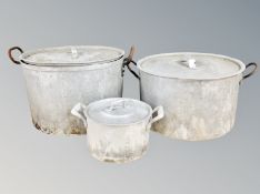 Three graduated aluminium lidded cooking pots