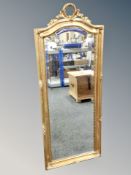 A gilt and gesso wall mirror, height 137 cm.