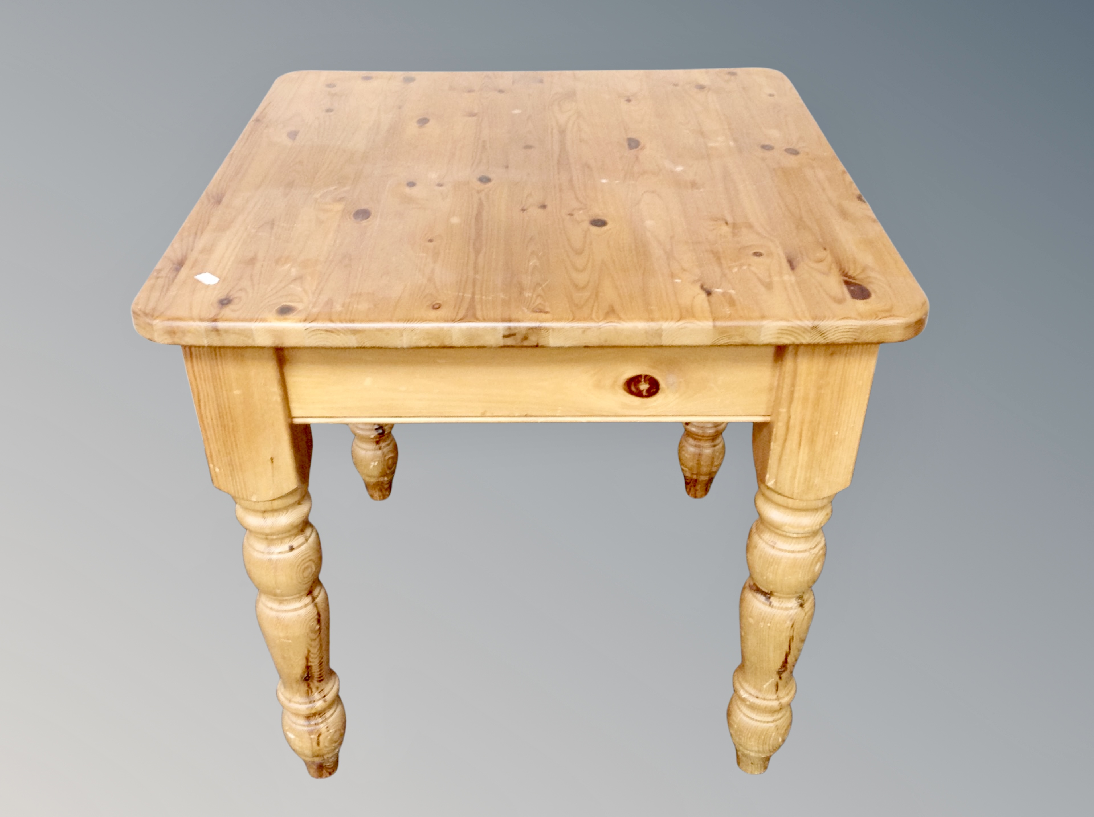 A square pine dining table and a set of four pine chairs