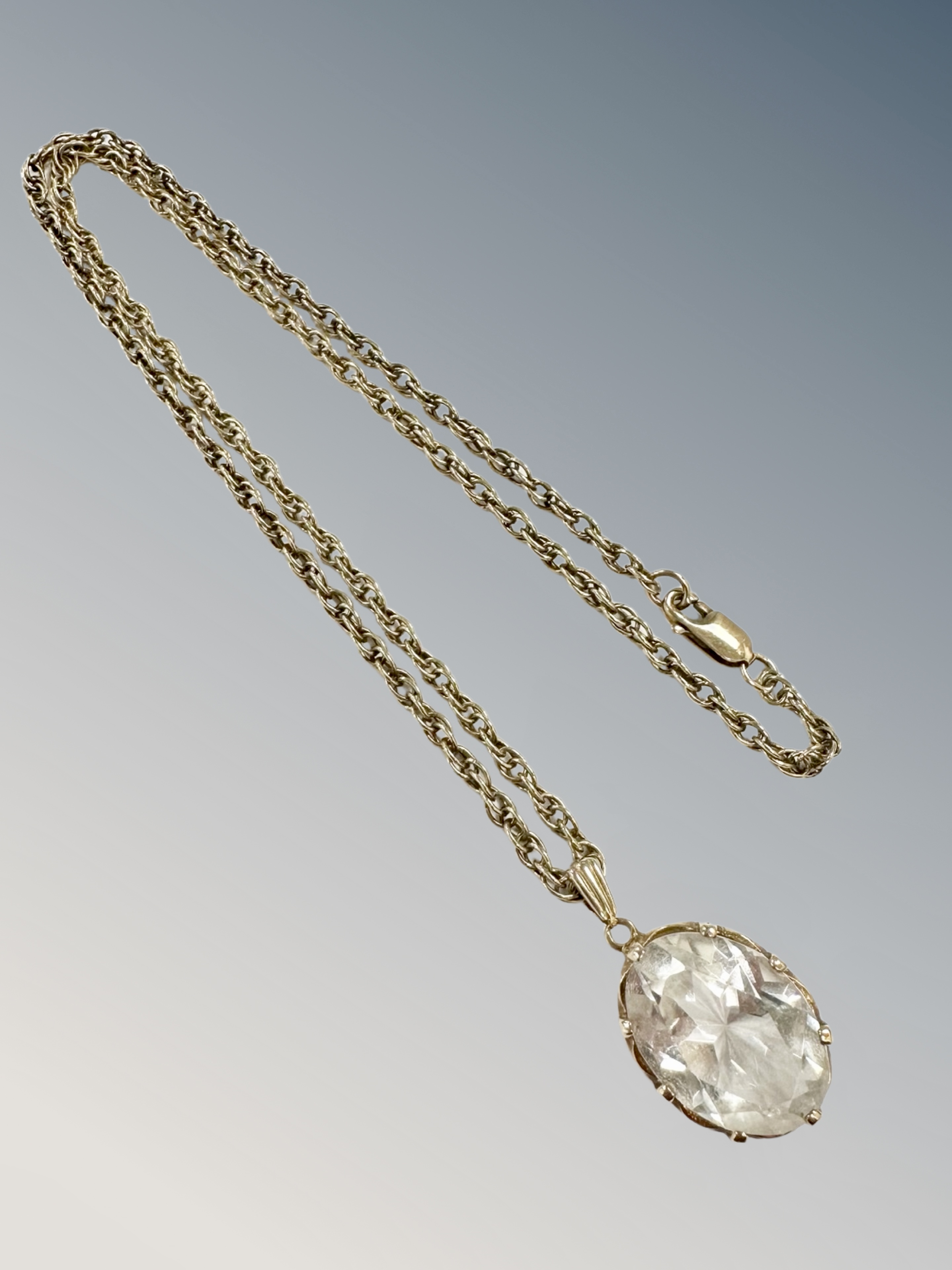 A 9ct gold crystal pendant on similar chain CONDITION REPORT: 13.