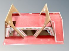 A painted plywood modeled garage, length 86 cm.