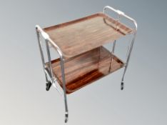 A 1960's rosewood effect and chrome metal drinks trolley on castors