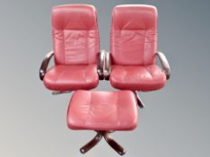 A pair of Scandinavian stained beech red leather armchairs with matching footstool
