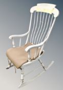 A Scandinavian cream spindle backed rocking chair