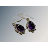 An old pair of silver and amethyst earrings