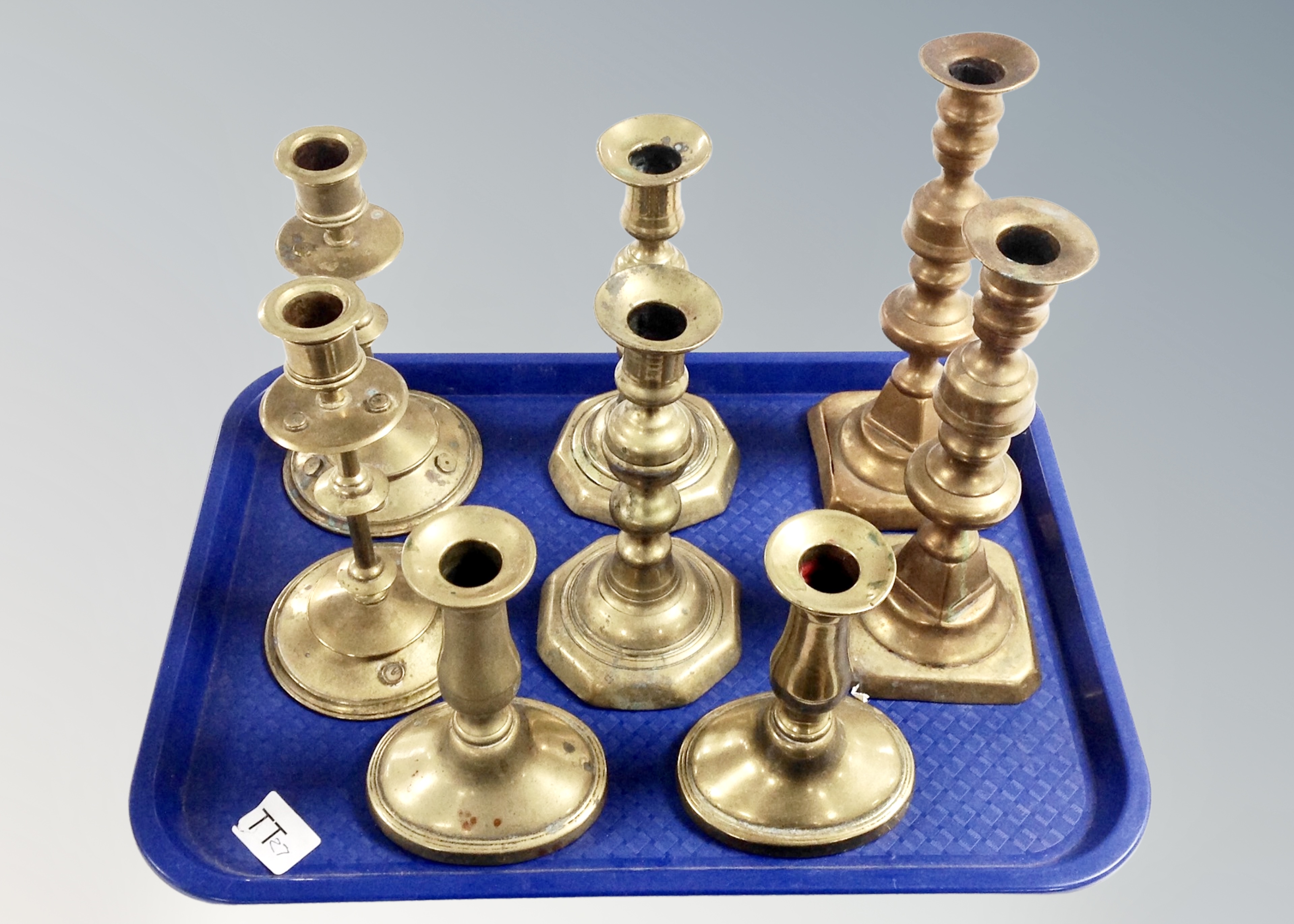 Four pairs of brass candlesticks.