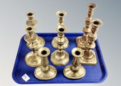 Four pairs of brass candlesticks.