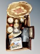 A box containing gilt serving tray, barometers and clocks, vintage pastry knife, postcards.