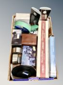 A box of assorted clocks and thermometers, cased field glasses, boxed camera tripod,