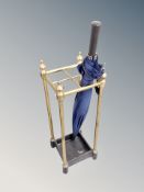 A cast iron and brass stick stand with umbrella