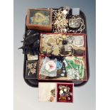 A tray containing assorted costume jewelry, metal mesh purses, faux pearls, locket on chain etc.