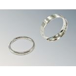 Two platinum band rings, the thinner ring size I½, the broader ring size O.