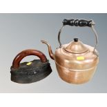 A cast iron smoothing iron together with a copper kettle