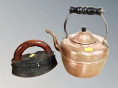 A cast iron smoothing iron together with a copper kettle