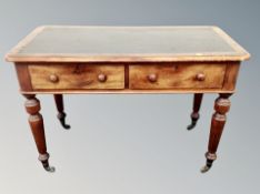A Victorian mahogany two-drawer side table with leather inset panel,