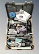 A box of tools including Bosch handheld hedge trimmer, circular saw, hand torches.