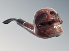 A vintage pipe with bowl modelled as a skull