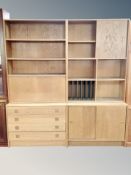 A Scandinavian oak veneered two section bookcase fitted with sliding doors,