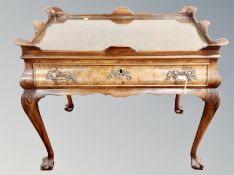 A George II style burr walnut silver table fitted a drawer on claw and ball feet,