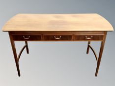 A Continental mahogany table fitted with three drawers,