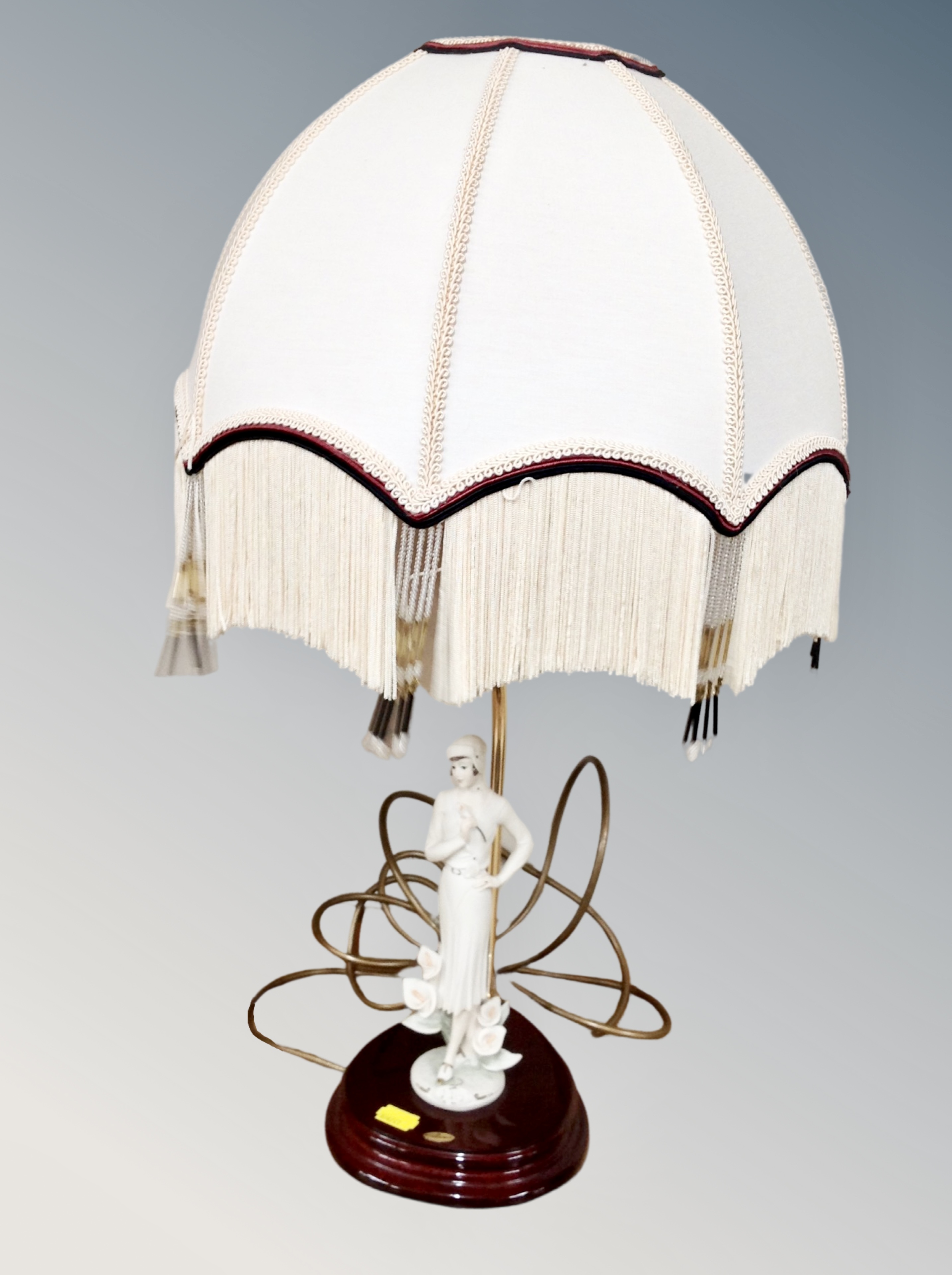 A Florence figural table lamp with tasseled shade
