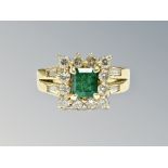 An 18ct gold emerald and diamond cluster ring, the emerald approximately 0.