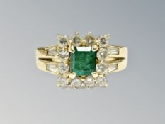 An 18ct gold emerald and diamond cluster ring, the emerald approximately 0.