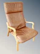 A beech framed armchair in tan leather
