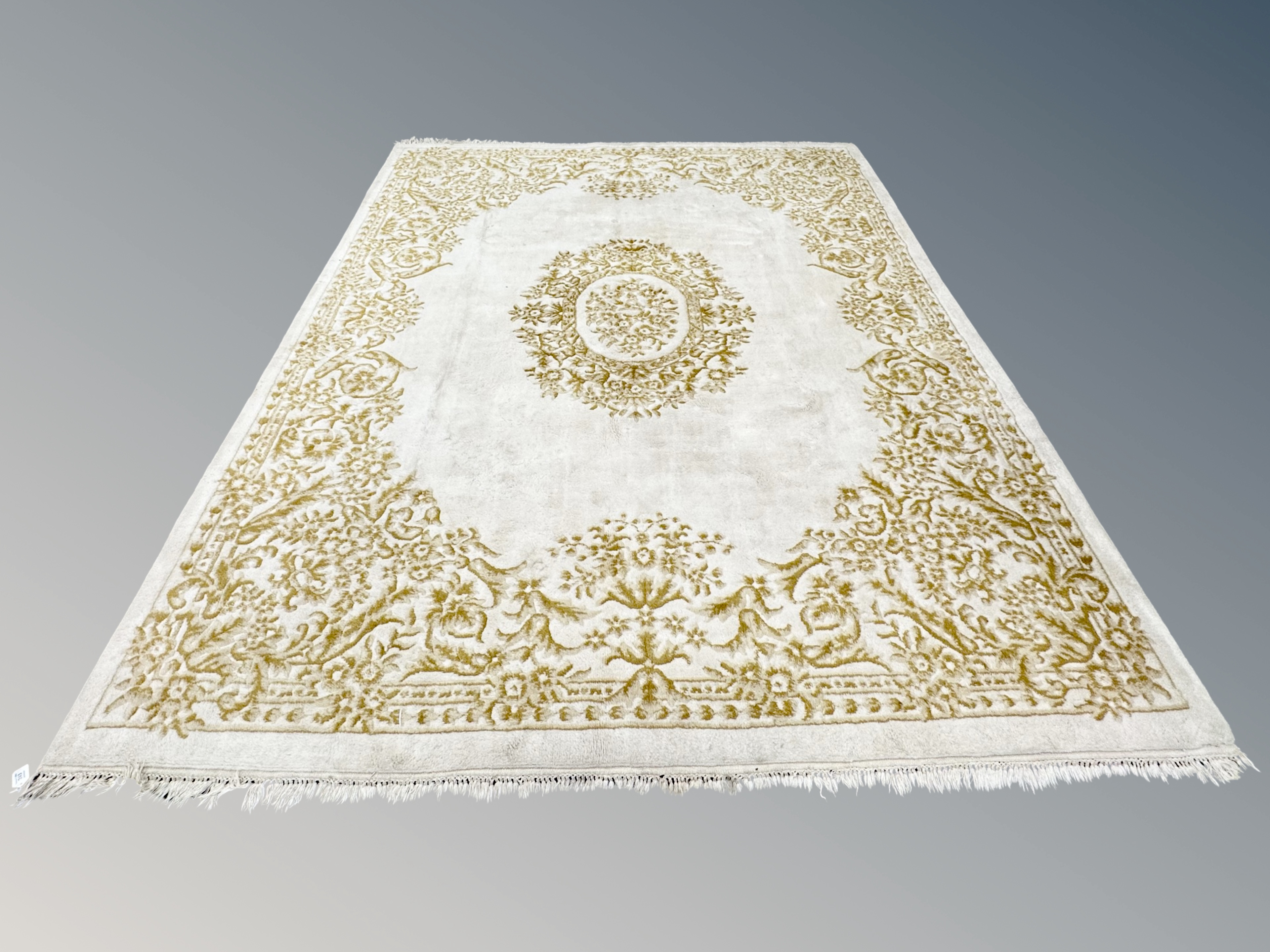 An Oriental rug on cream ground 322 cm x 280 cm